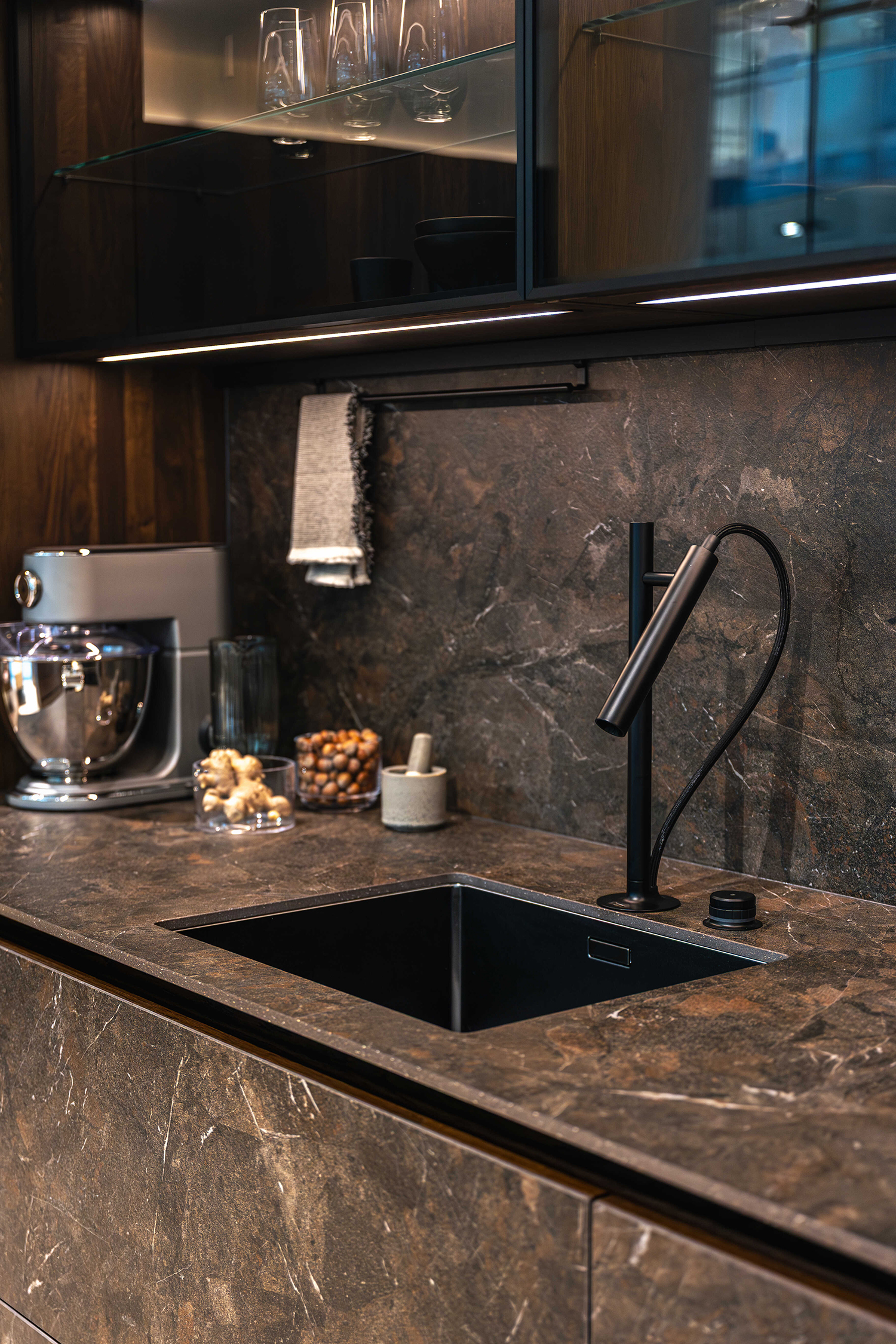 Modern kitchen with luxurious dark marble countertop.